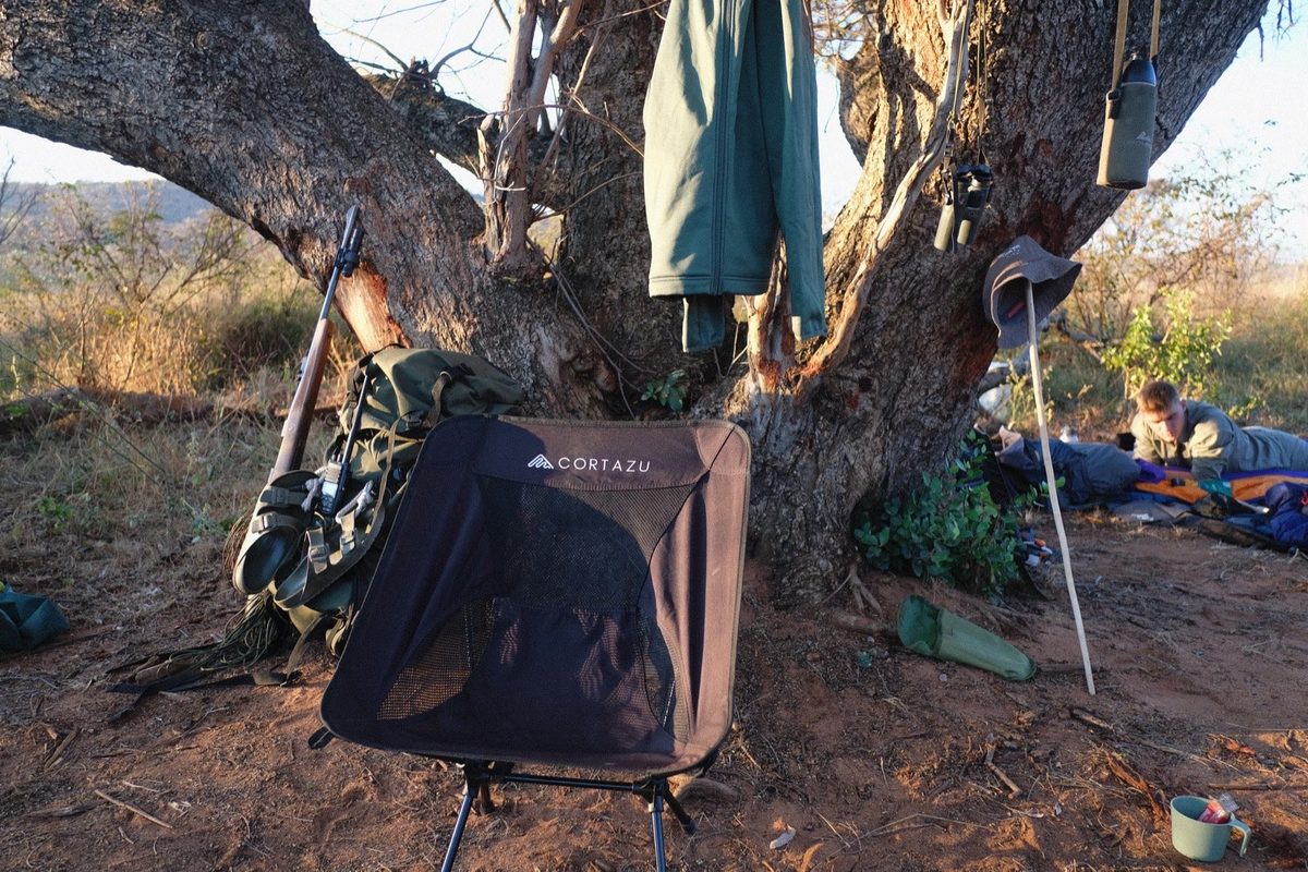 Camp on trail — packs down, kit hung from the branches