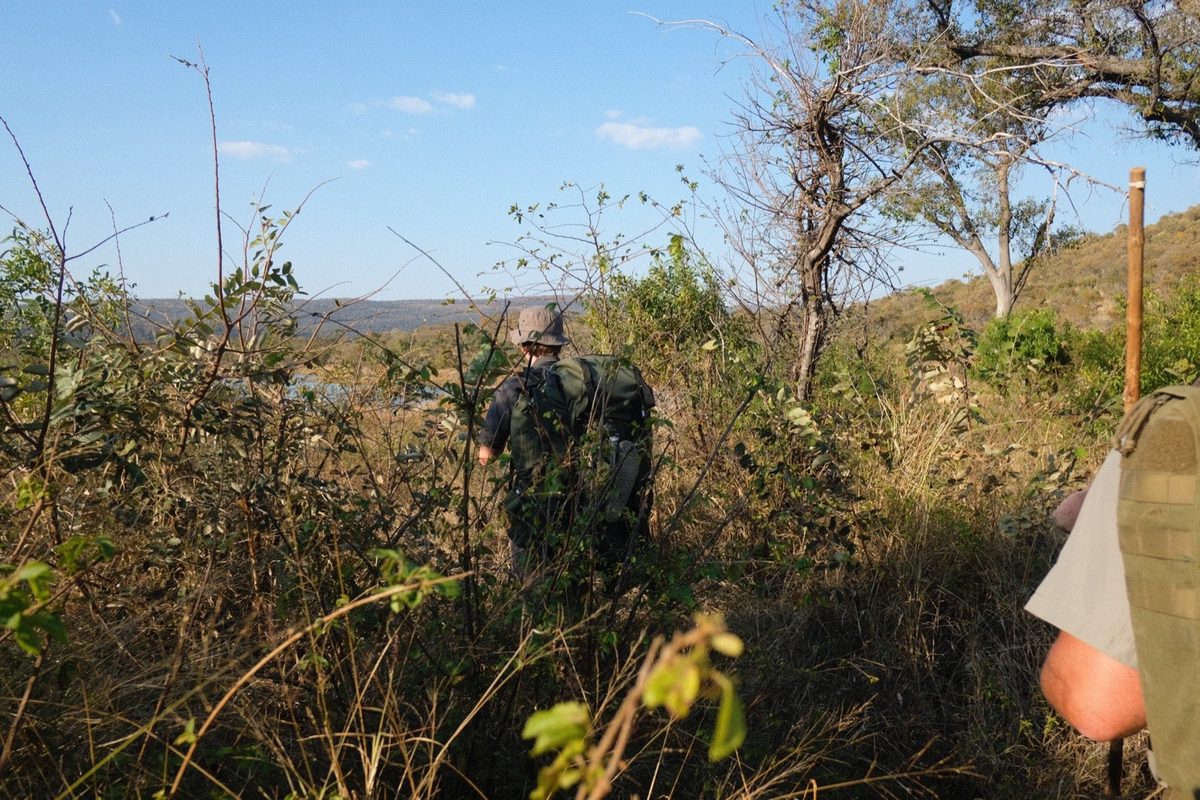 Dropping down toward water, packs on